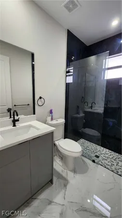 a bathroom with a sink toilet and shower