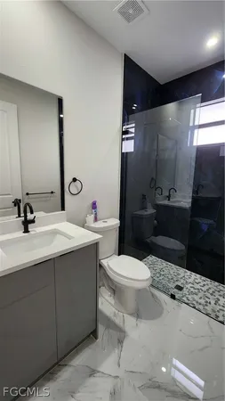 a bathroom with a sink toilet and shower