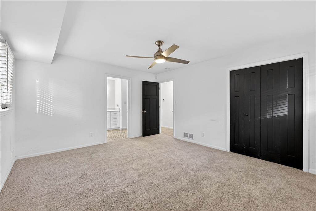 1200 Silver Hill Road Stone Mountain, GA 30087 - Photo 11 of 26 a view of an empty room with a ceiling fan