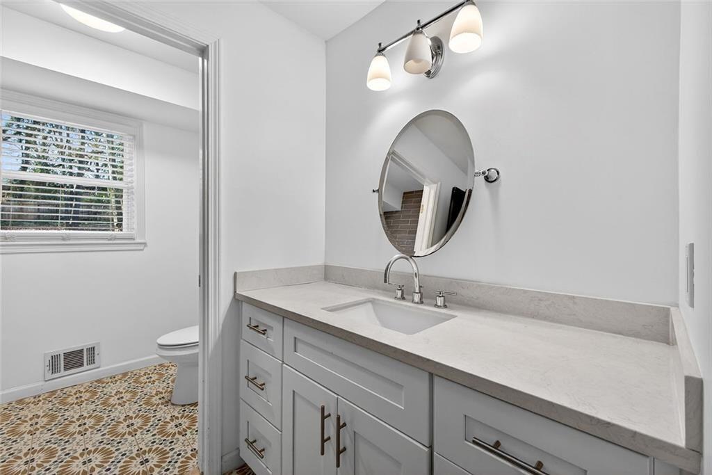 1200 Silver Hill Road Stone Mountain, GA 30087 - Photo 13 of 26 a bathroom with a sink and a mirror