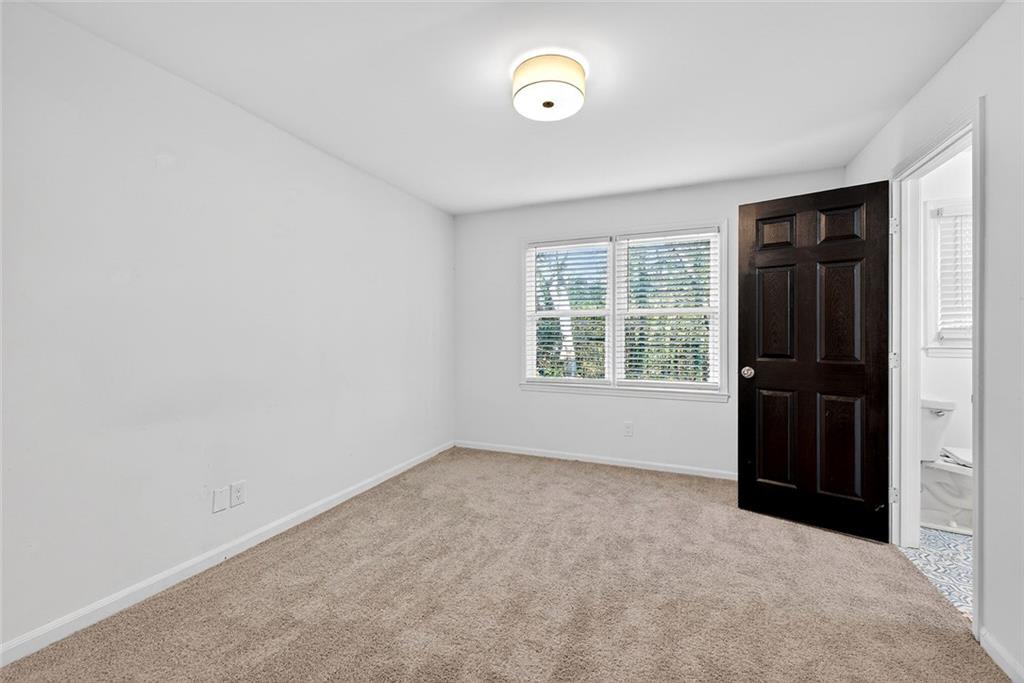 1200 Silver Hill Road Stone Mountain, GA 30087 - Photo 15 of 26 an empty room with windows and closet