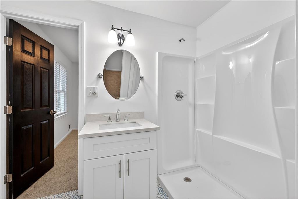 1200 Silver Hill Road Stone Mountain, GA 30087 - Photo 16 of 26 a bathroom with a sink a toilet and shower