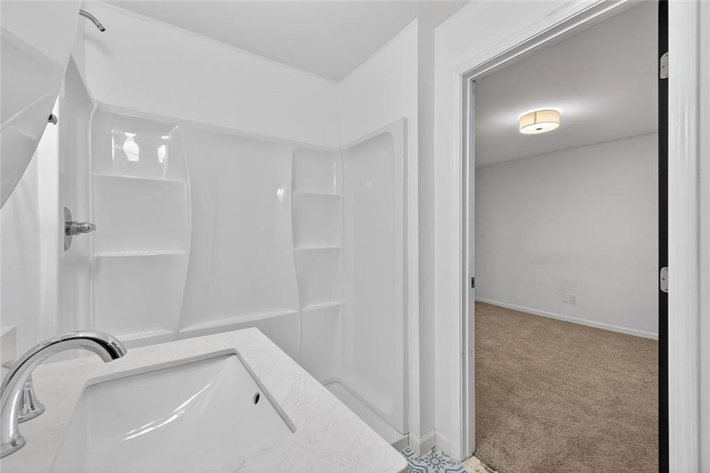 1200 Silver Hill Road Stone Mountain, GA 30087 - Photo 17 of 26 a bathroom with a bathtub and shower