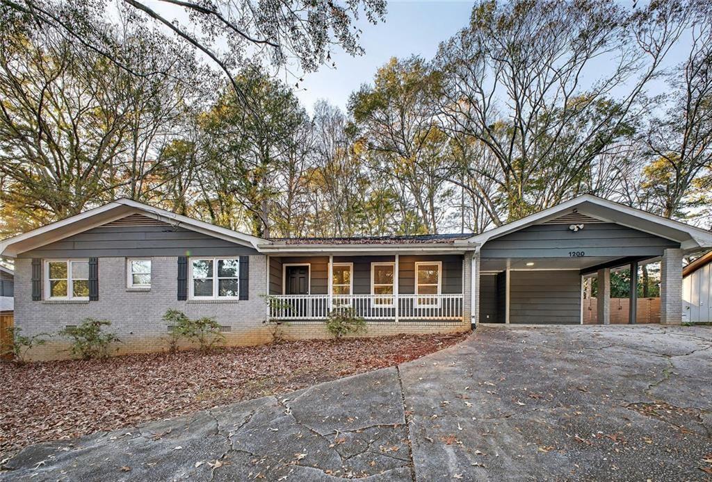 1200 Silver Hill Road Stone Mountain, GA 30087 - Photo 3 of 26 front view of a house with a yard