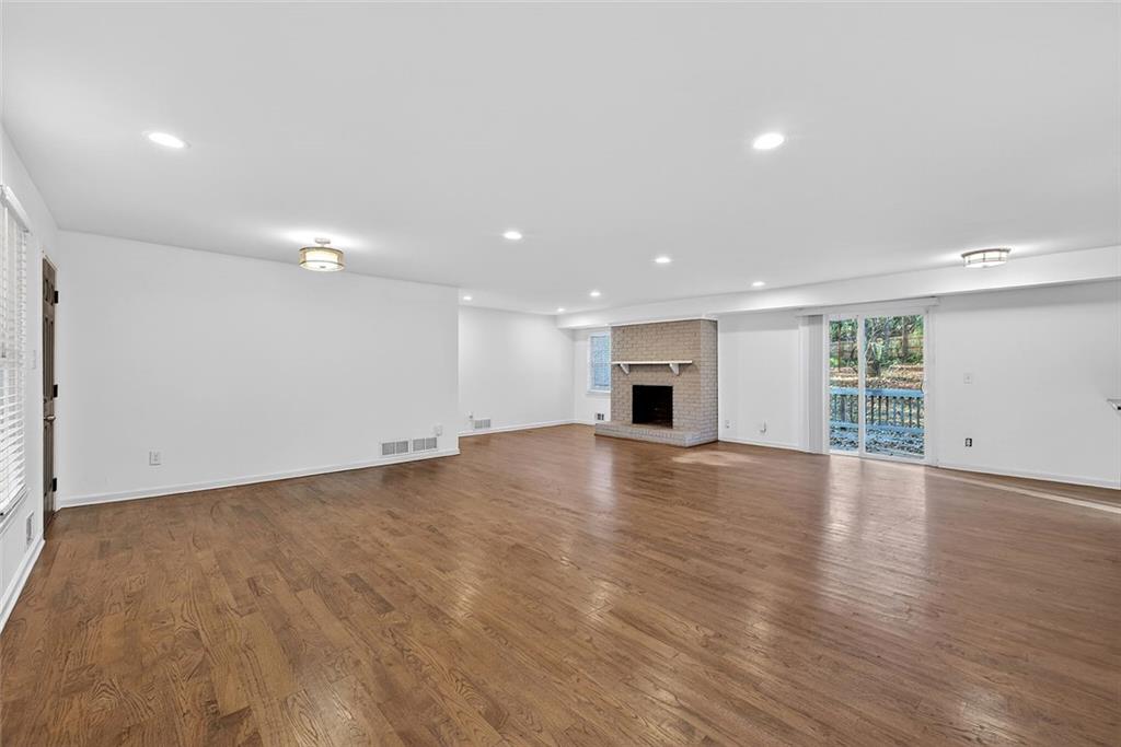 1200 Silver Hill Road Stone Mountain, GA 30087 - Photo 5 of 26 a view of an empty room with wooden floor and a window