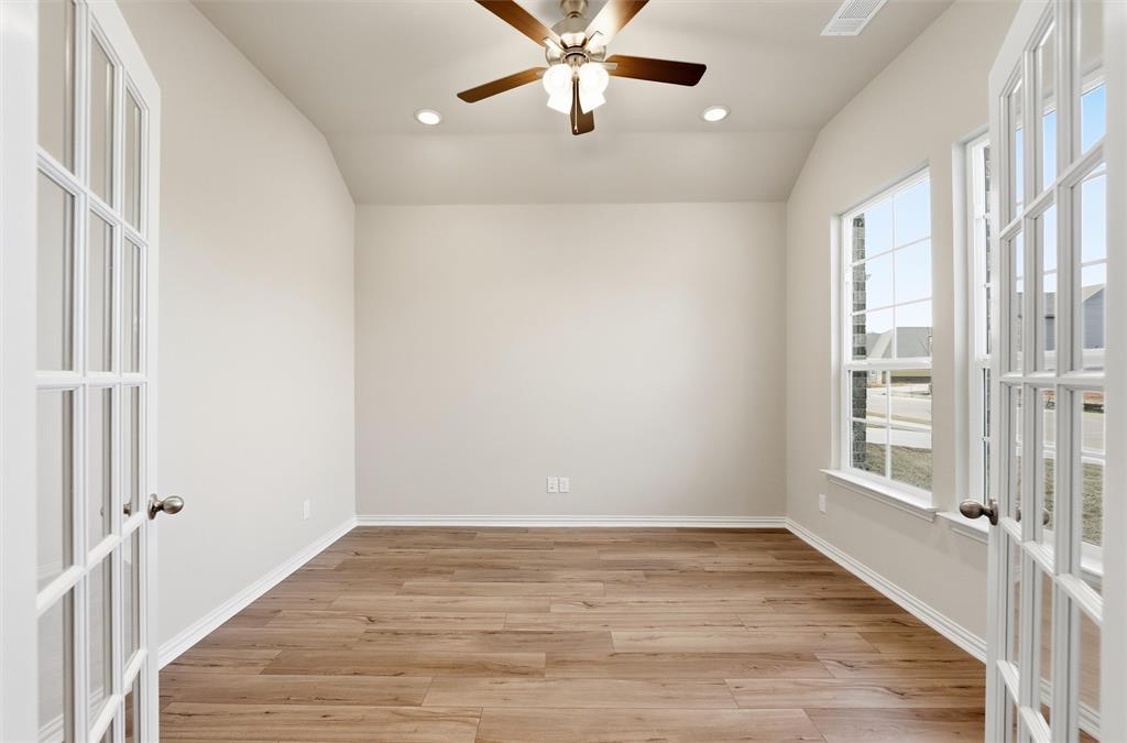1244 Sabine River Lane Springtown, TX 76082 - Photo 7 of 26 Empty room featuring french doors, vaulted ceiling, light wood-style floors, recessed lighting, and ceiling fan