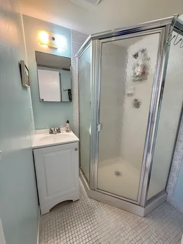 a view of a table and chairs under an umbrella in a yard