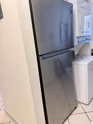 a living room with furniture and a lamp