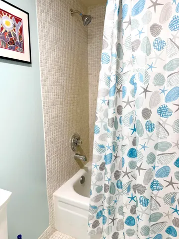 a large bedroom with a bed and a window