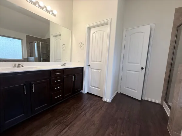 a spacious bathroom with a double vanity sink and mirror