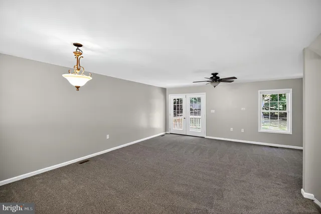 a view of a chandelier fan and windows