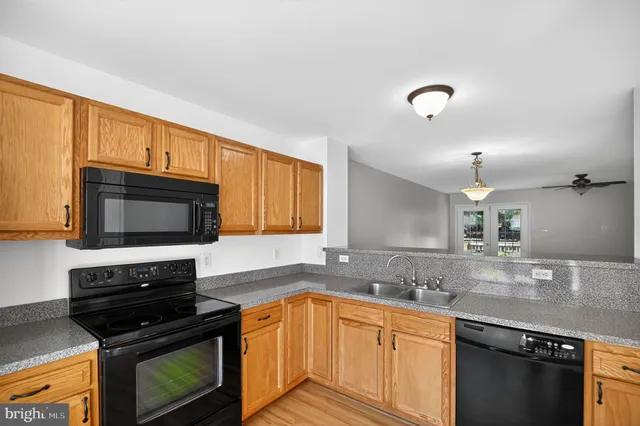 a kitchen with stainless steel appliances granite countertop a stove microwave and sink