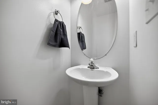 a bathroom with a sink and mirror