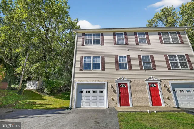 a front view of house with yard and green space