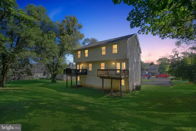 a backyard of a house with table and chairs