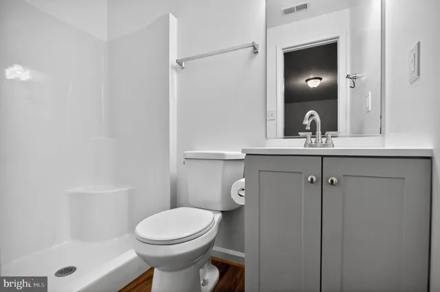 a bathroom with a toilet a sink and shower