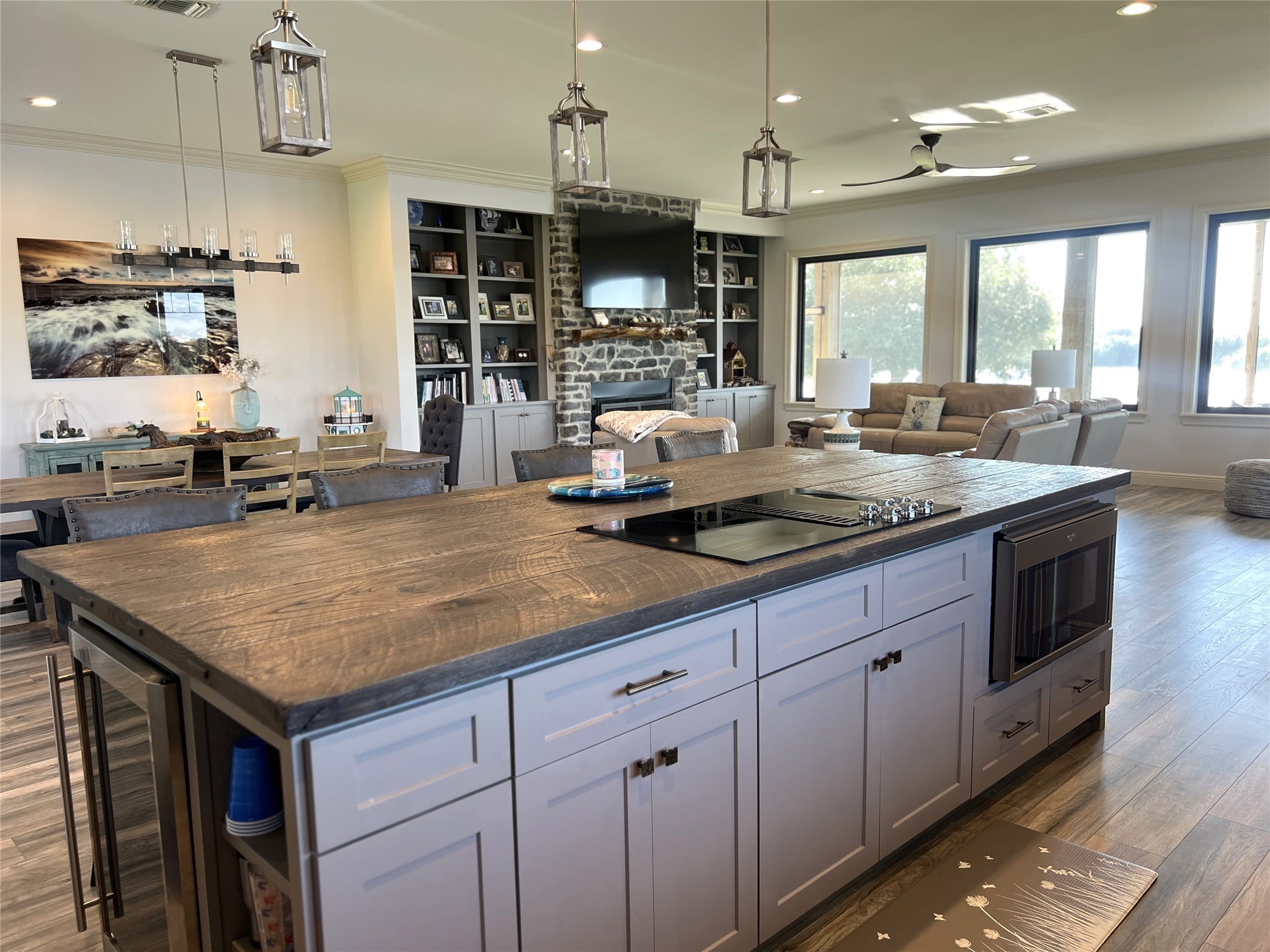7165 Backridge Road Sabine Pass, TX 77655 - Photo 11 of 49 a kitchen with kitchen island a counter top a stove a sink and a refrigerator