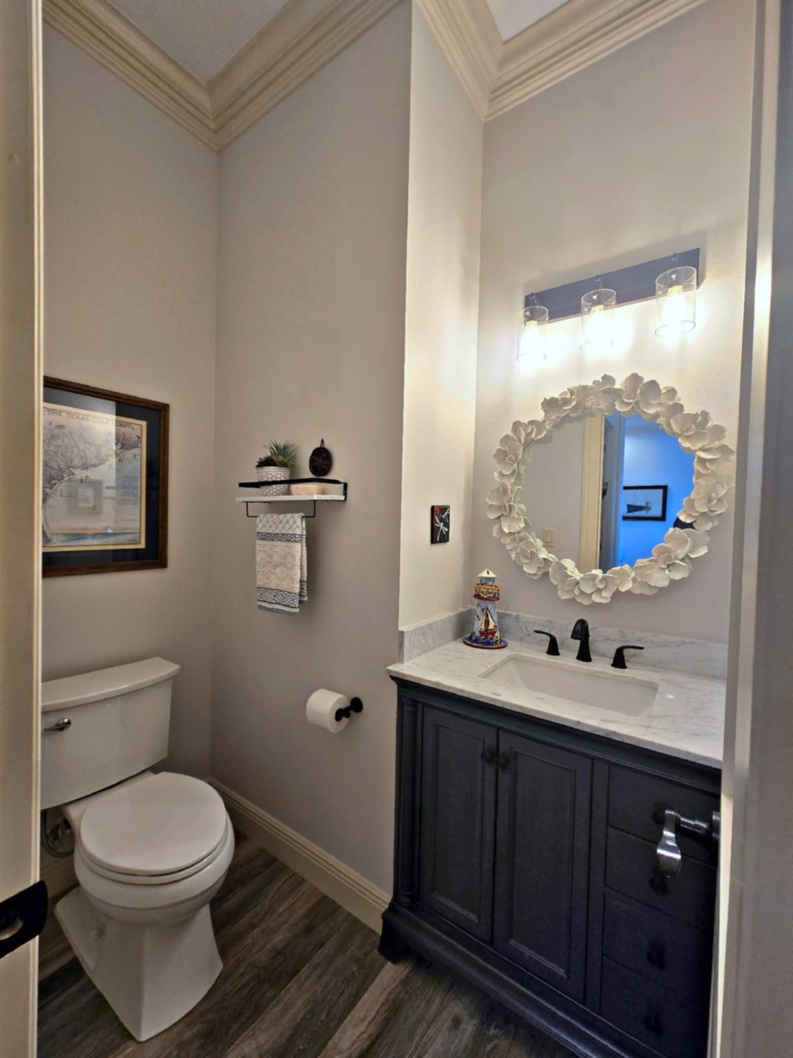 7165 Backridge Road Sabine Pass, TX 77655 - Photo 12 of 49 a bathroom with a toilet a sink a mirror and vanity
