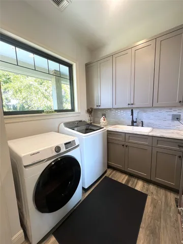 a kitchen with a sink cabinets and window