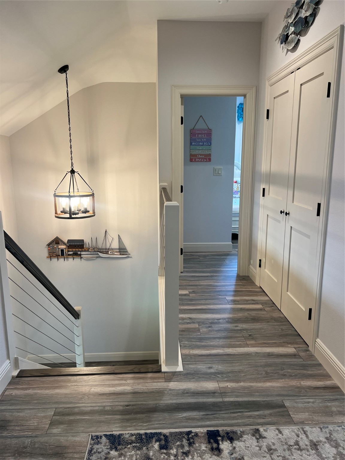 7165 Backridge Road Sabine Pass, TX 77655 - Photo 20 of 49 a view of a hallway with wooden floor and staircase