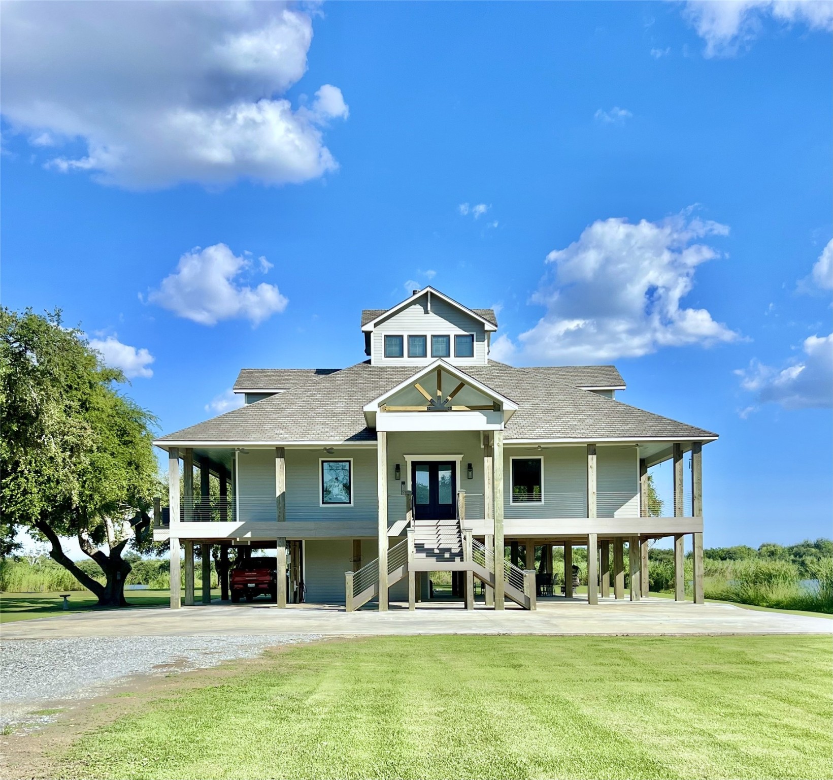 7165 Backridge Road Sabine Pass, TX 77655 - Photo 2 of 49 a front view of a residential houses with yard and green space
