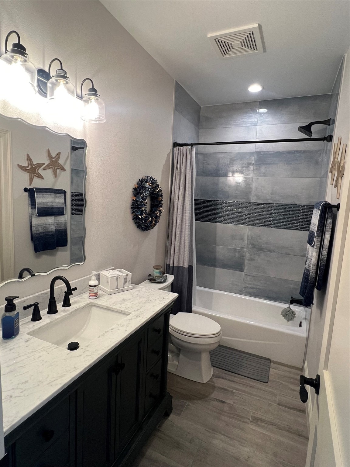 7165 Backridge Road Sabine Pass, TX 77655 - Photo 22 of 49 a bathroom with a sink toilet a mirror and shower