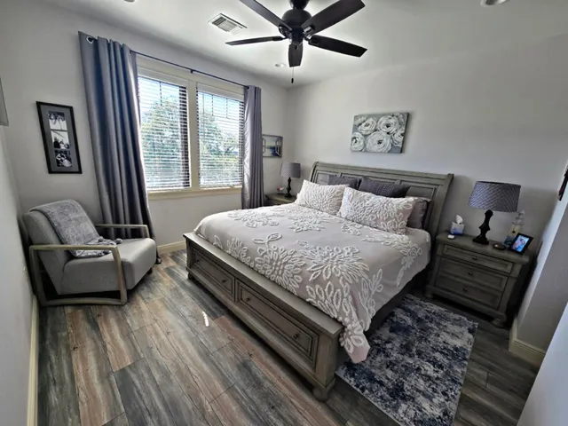 a bedroom with a bed and wooden floor