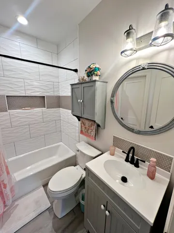 a bathroom with a sink toilet and shower