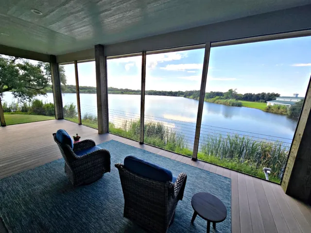 a living room with couch and a floor to ceiling window