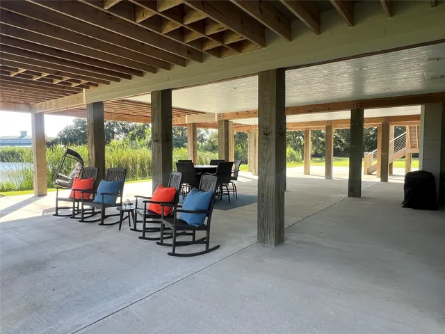a view of a patio with table and chairs next to a yard