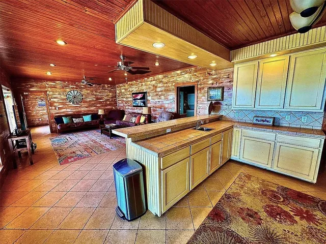 a kitchen with a sink appliances and cabinets
