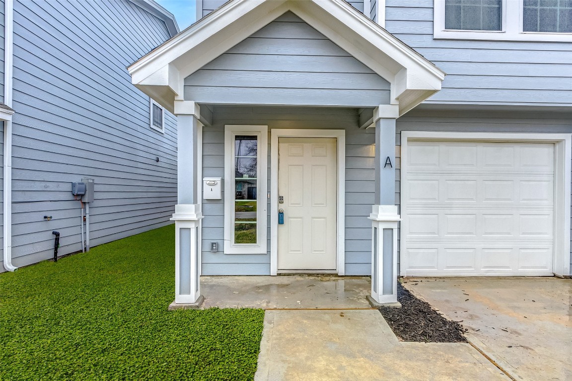 8113 Corinth Street, Unit B Houston, TX 77051 - Photo 3 of 15 a front view of a house with a yard