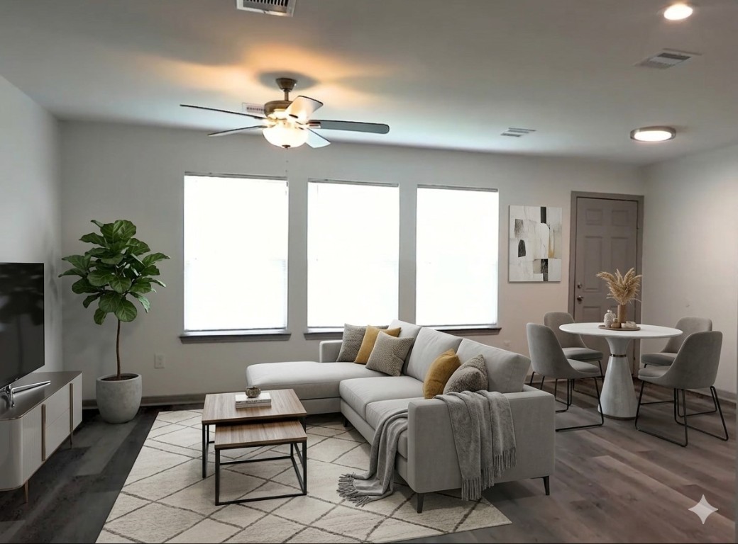 8113 Corinth Street, Unit B Houston, TX 77051 - Photo 5 of 15 a living room with furniture a chandelier and a window