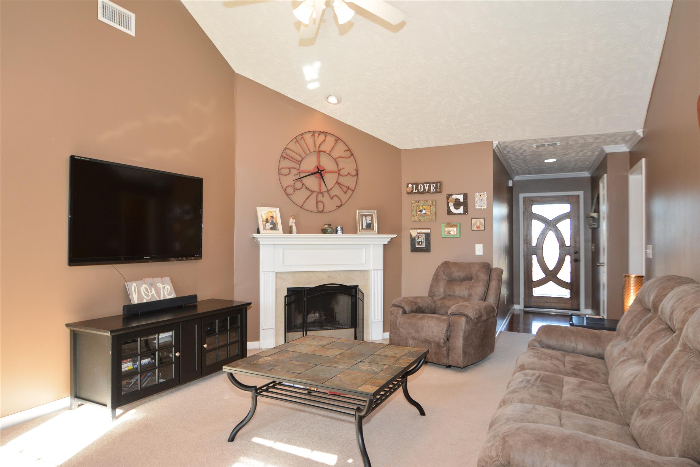 2026 Red Jacket Trace Spring Hill, TN 37174 - Photo 5 of 28 Living room features vaulted ceilings and a wood burning fireplace!
