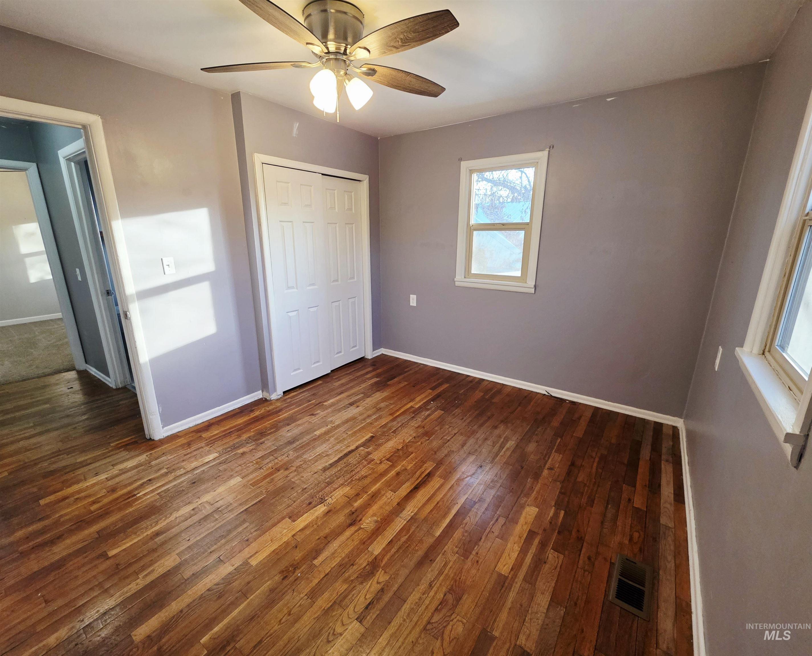 2127 12th Avenue Lewiston, ID 83501 - Photo 13 of 27 Unfurnished bedroom with dark wood-type flooring, ceiling fan, and a closet