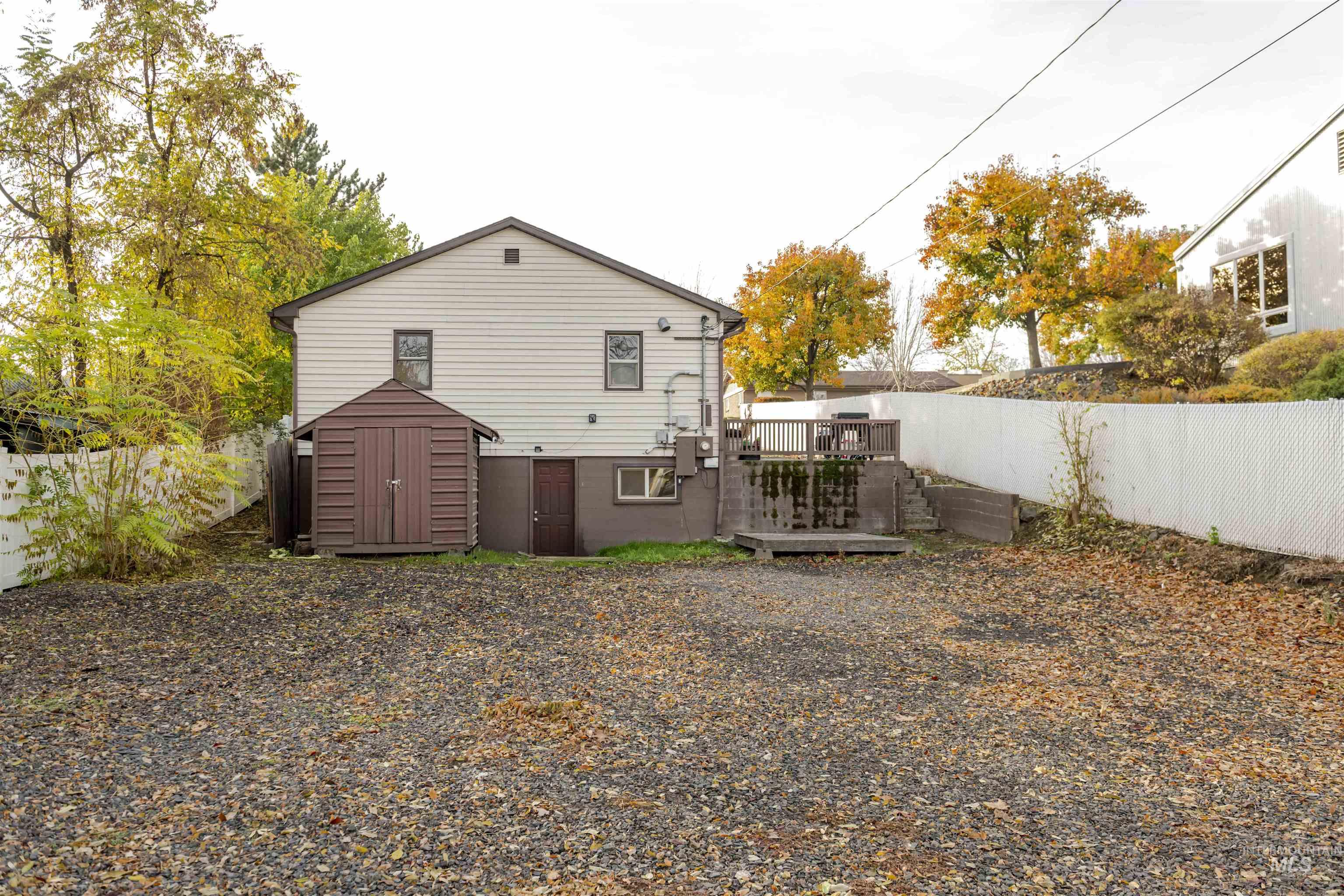2127 12th Avenue Lewiston, ID 83501 - Photo 18 of 27 Back of property featuring a storage shed, a deck, and a fenced backyard