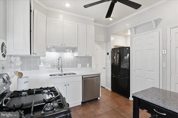 a kitchen with a sink stove and refrigerator