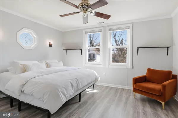 a bedroom with a bed couch and window
