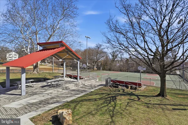a backyard of a house with barbeque oven and wooden fence