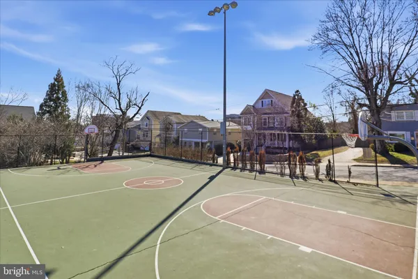 a tennis court with view of houses