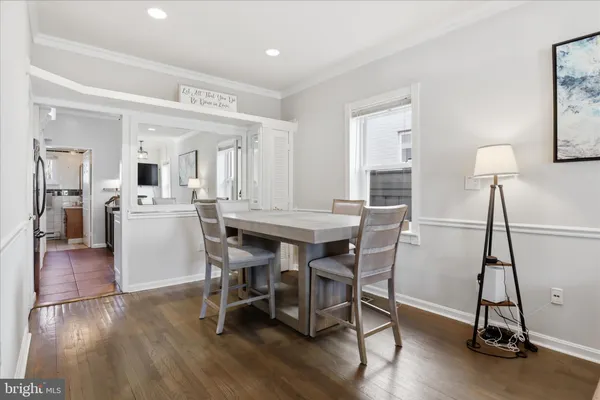 a dining room with furniture and wooden floor