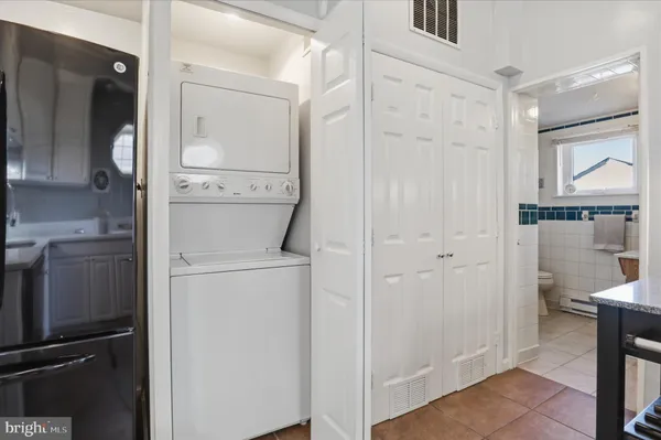 a utility room with cabinets washer and dryer