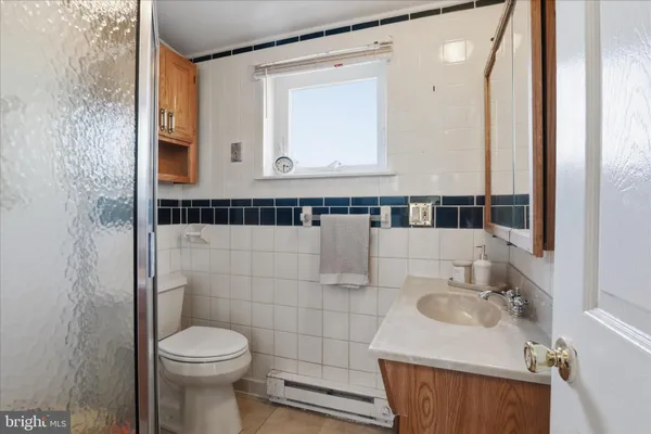 a bathroom with a sink a toilet and mirror