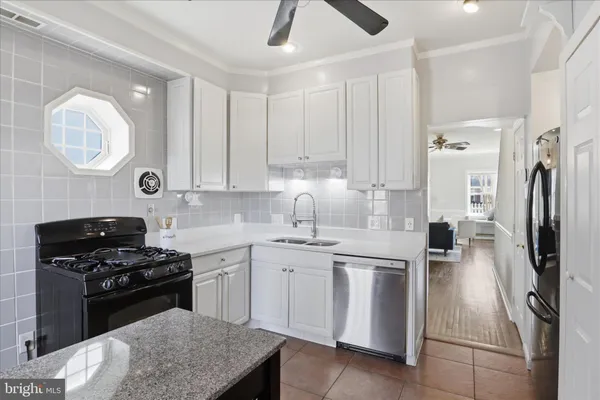 a kitchen with a sink appliances and cabinets