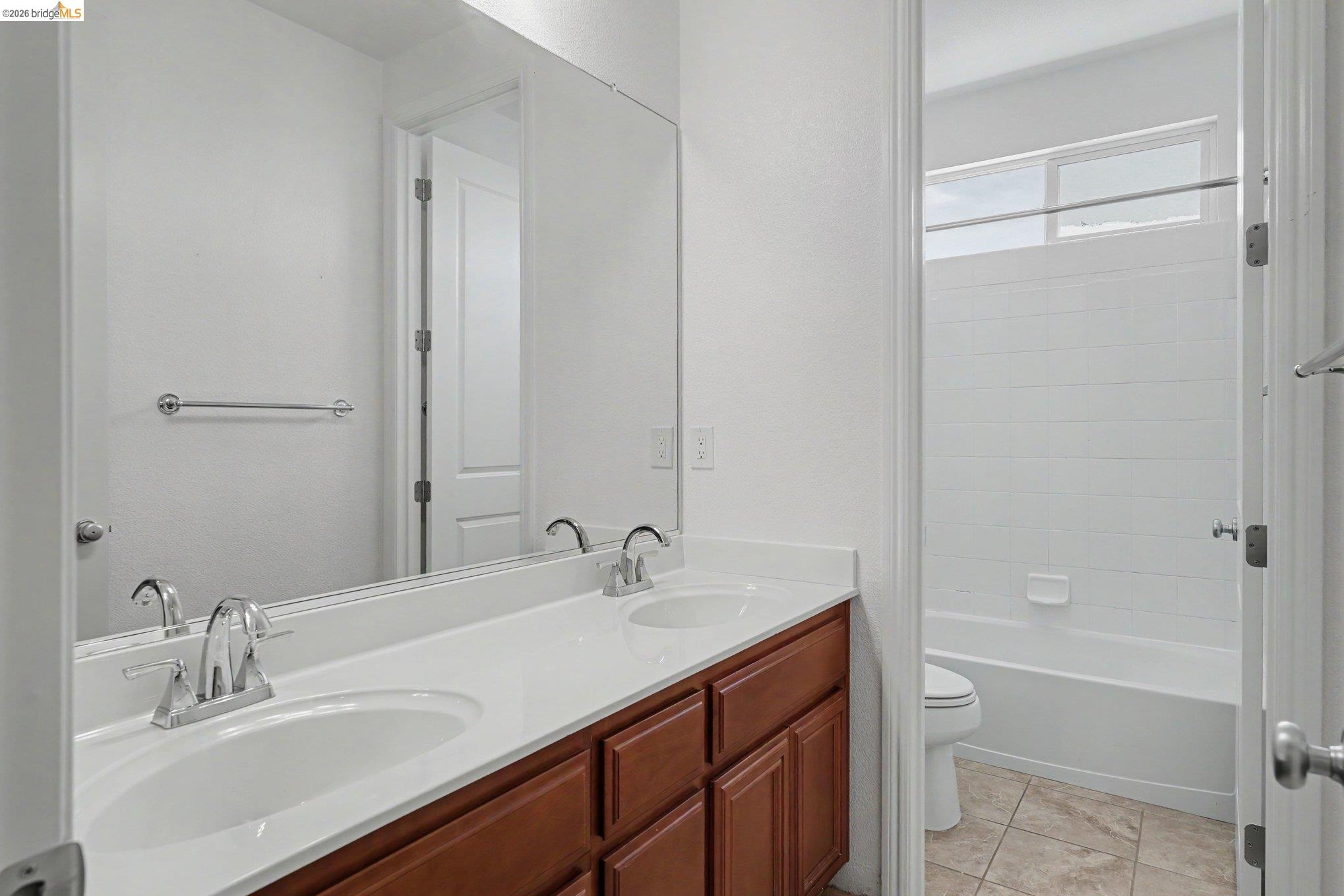 106 Little Ranch Circle Oakley, CA 94561 - Photo 19 of 34 Dual sink vanity with a white countertop and wood-finish cabinetry