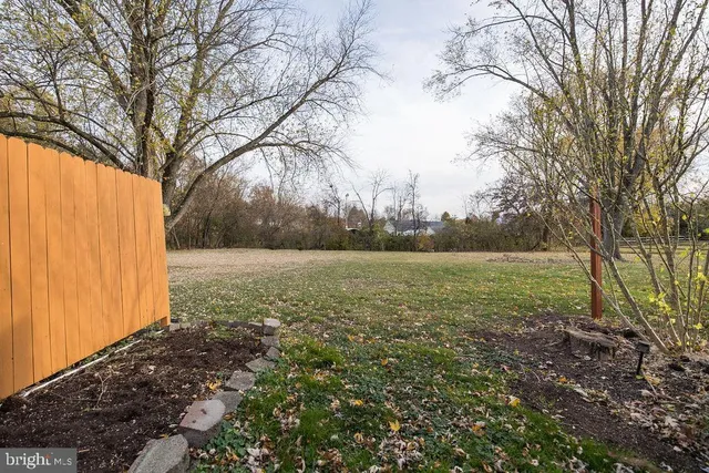 a view of a house with backyard and wooden door