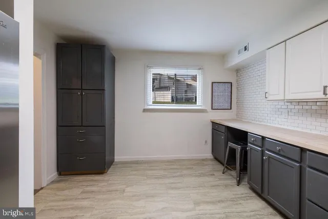 a kitchen with a refrigerator and a sink