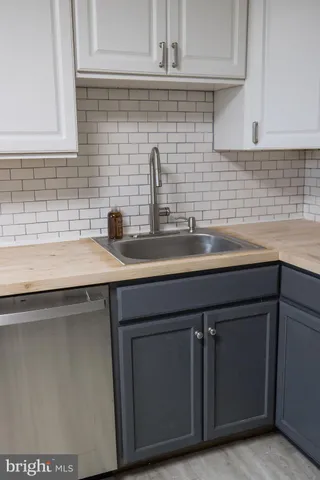 a kitchen with a sink and cabinets