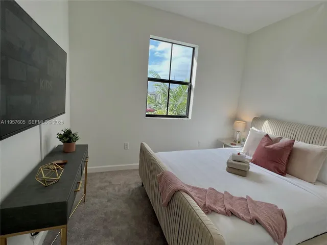 a bed sitting in a bedroom next to a window