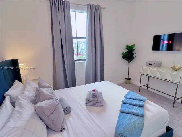 a bedroom with bed and window